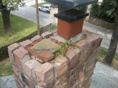 Beautiful heavy stone was added to this existing chimney. The extra weight caused the fireplace to pull away from the exterior wall. They had no clue how to install a proper chimney crown...thus the grass growing on top.