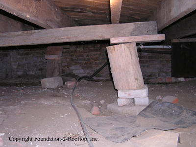 Firewood supporting the floor joists.