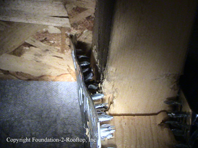 Attic truss with the teeth of the gusset plate pulled all the way out.