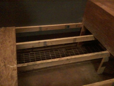 Garage style floor grate hidden under the built-in bed.