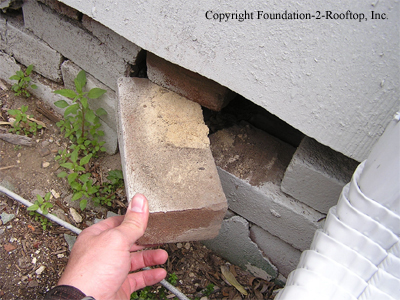 Deteriorated brick foundation wall.